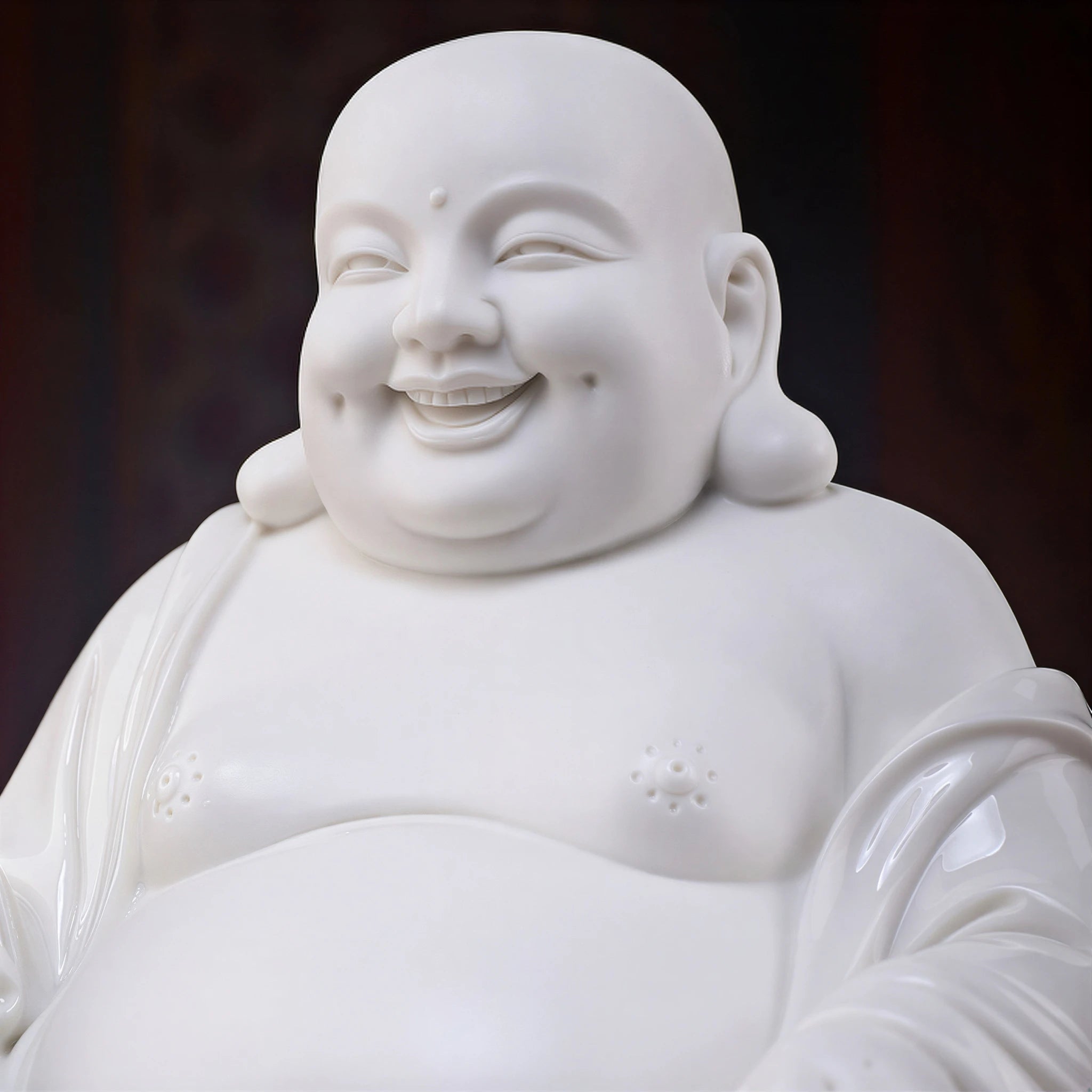 Close view of the smiling face and modeled features of the Dehua Maitreya