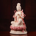 Angled view of jade-red Manjushri seated on the porcelain lotus base