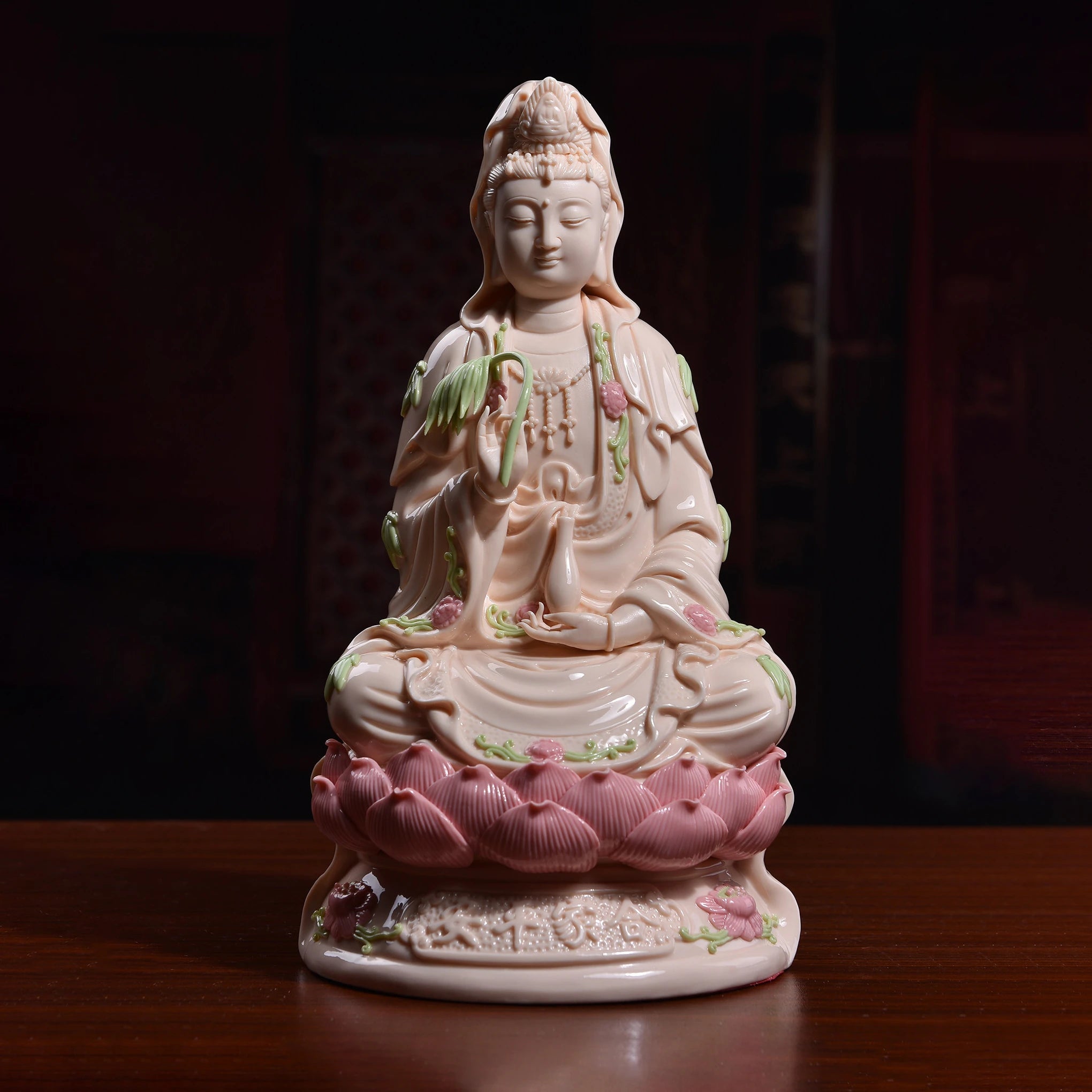 Full view of the rose-glazed Nanhai Guanyin seated on a pink lotus