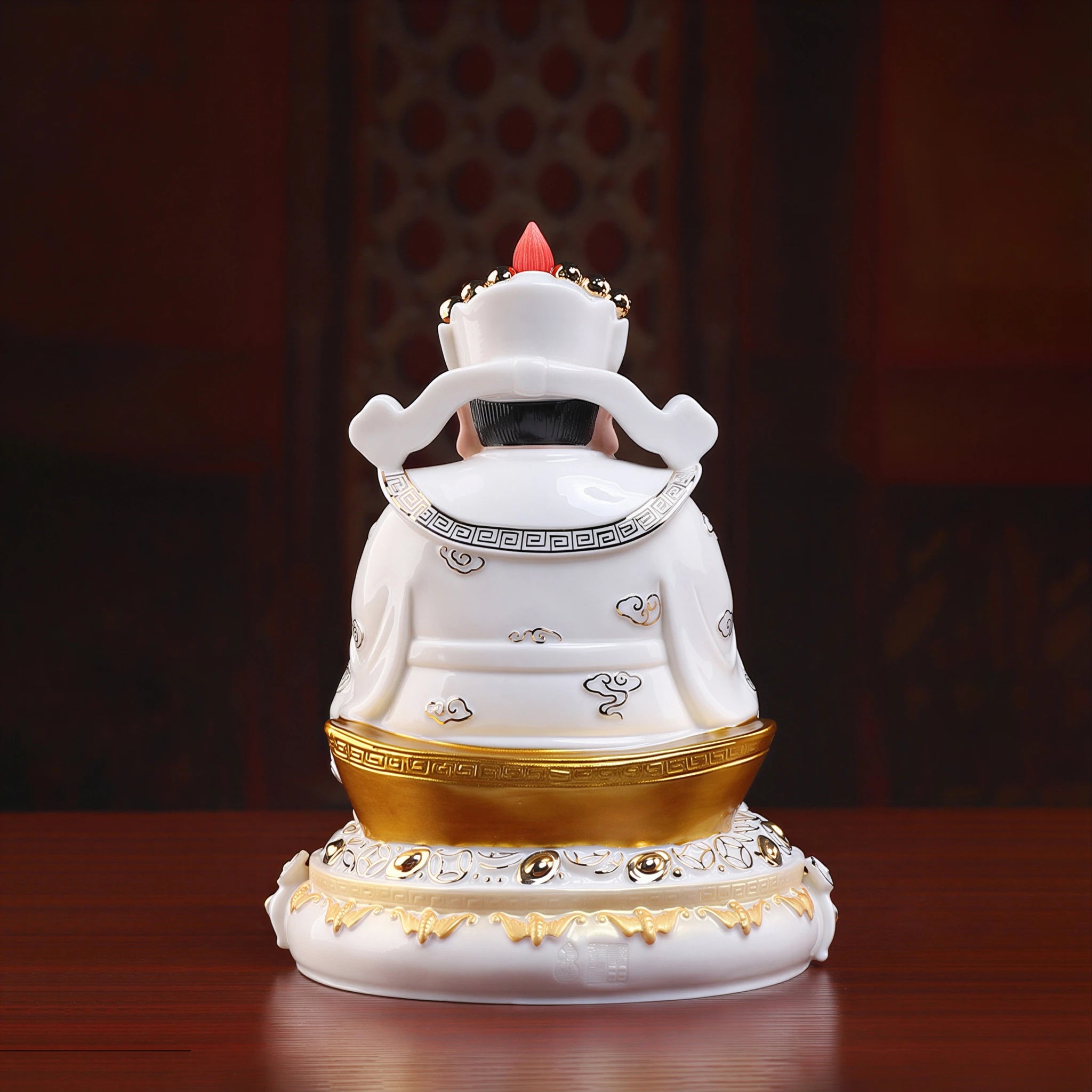 Back view of the white glazed robes and gold-toned details