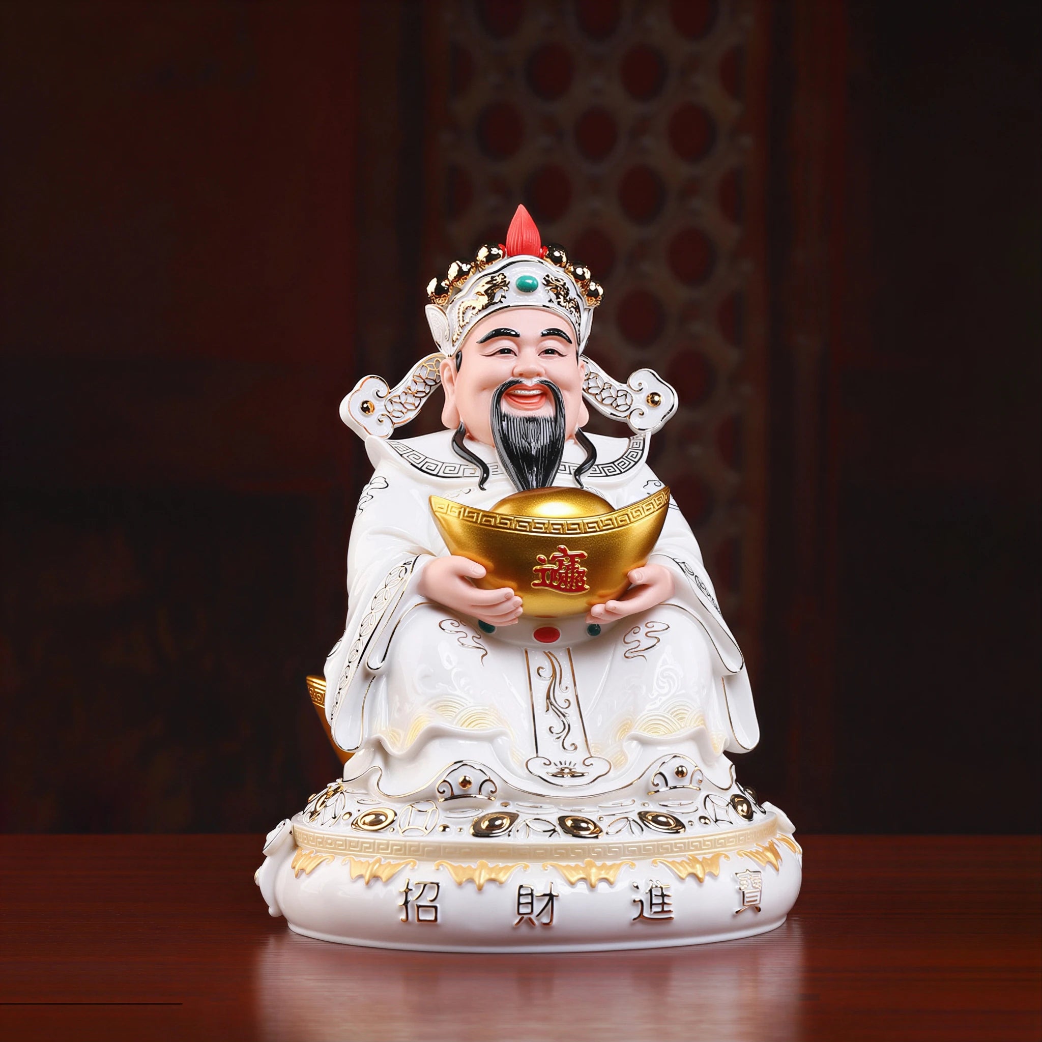 Angled view of a Dehua Caishen sculpture with gold-toned details