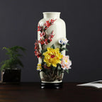 Full view of the Dehua vase with red plum blossom, peony and orchid relief