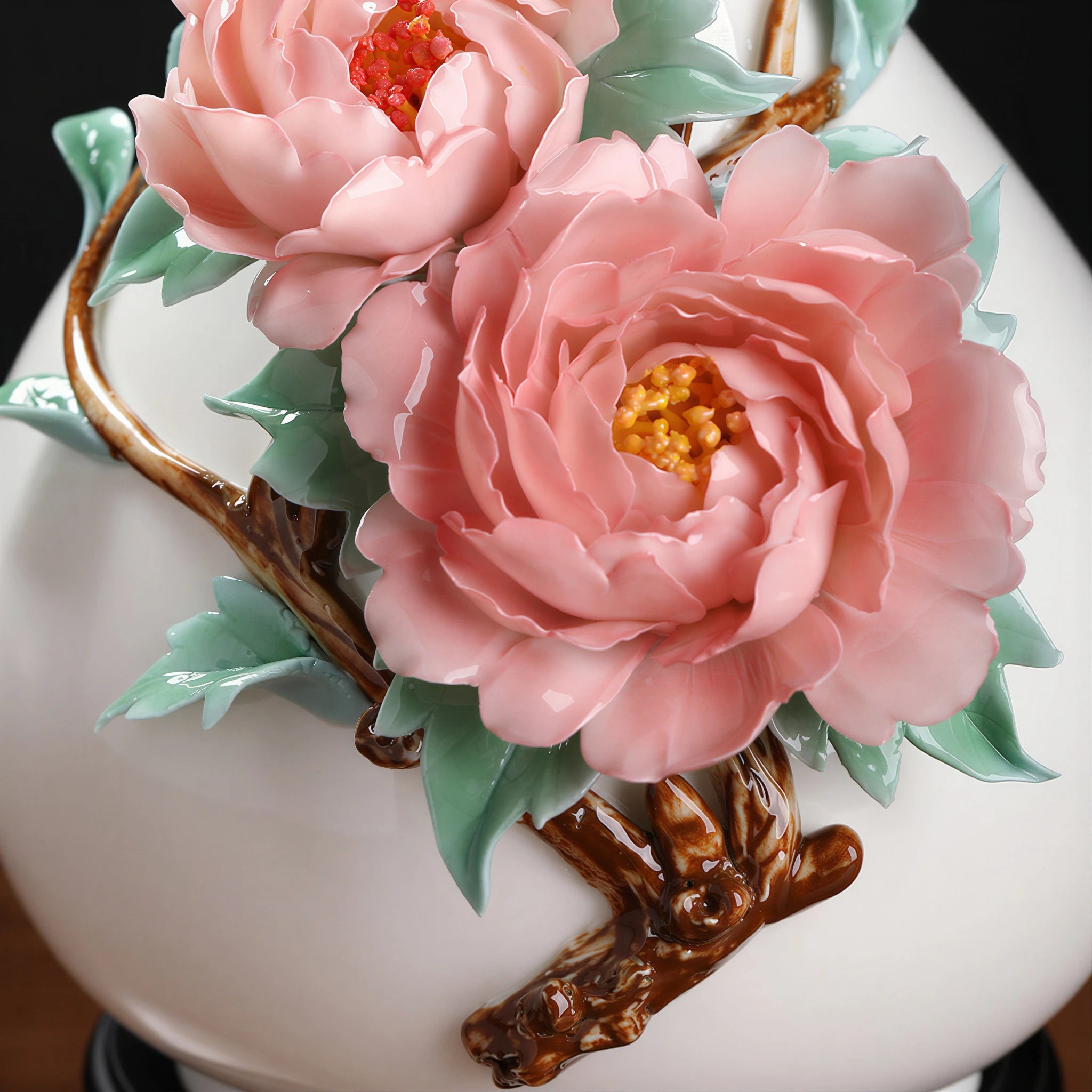 Detailed view of pink peonies, green leaves and the brown applied branch