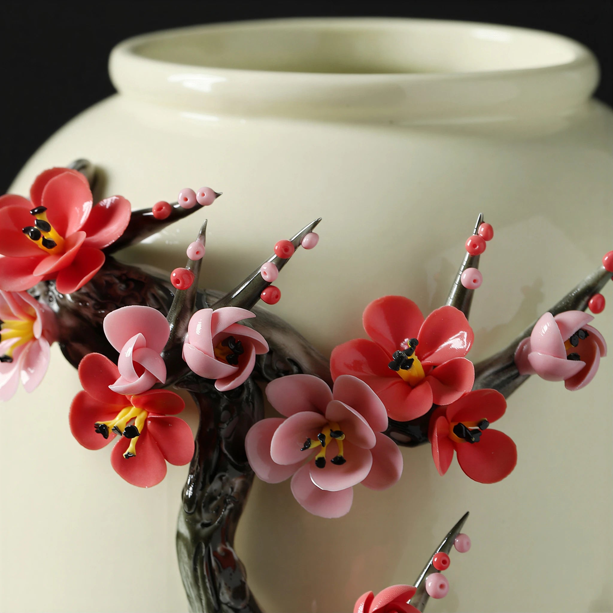 Applied plum branch and blossoms projecting from the porcelain body