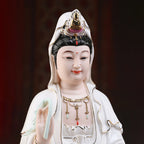 Close view of the Guanyin face, headdress and colored jewelry details
