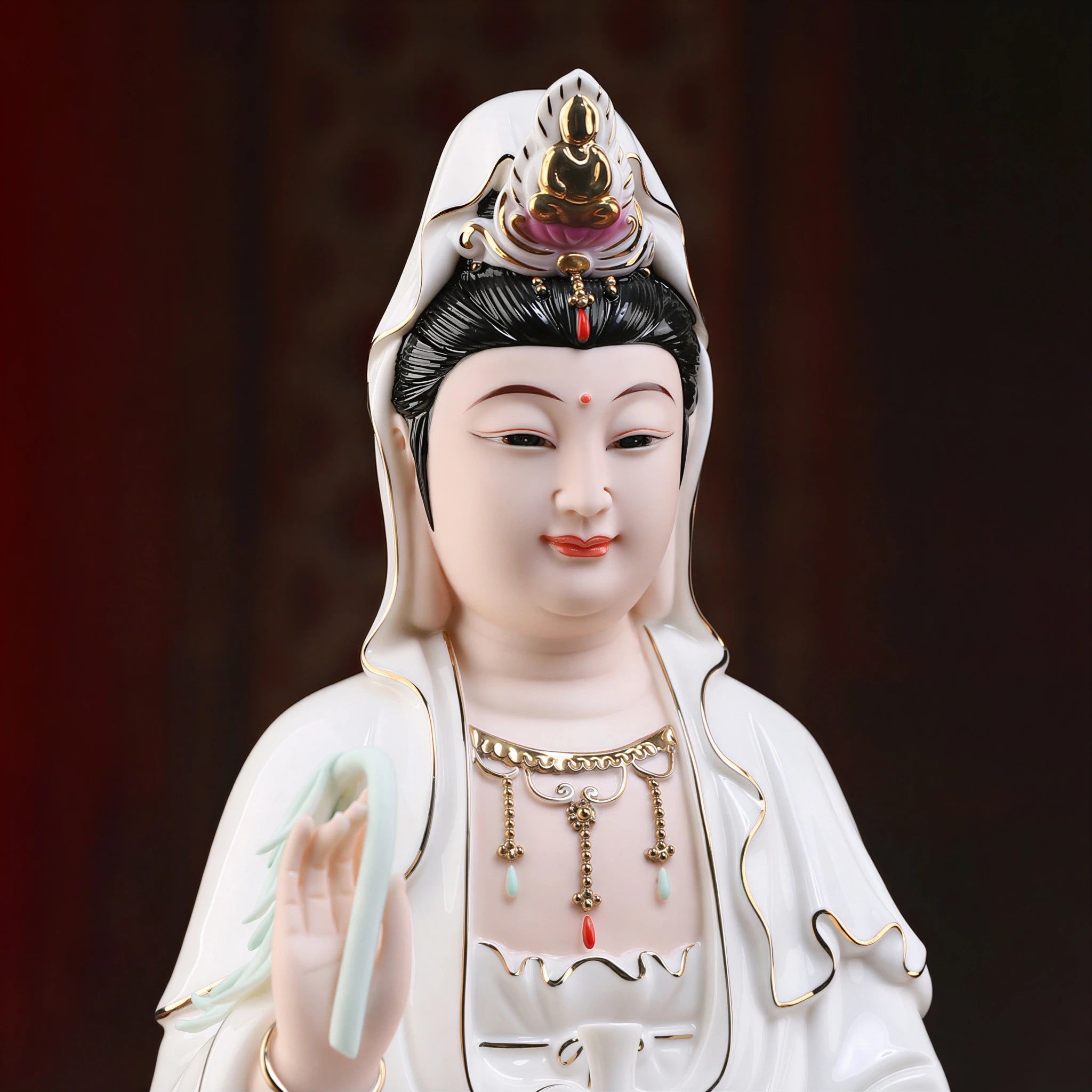 Close view of the Guanyin face, headdress and colored jewelry details