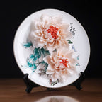 Angled view of hand-modeled peonies on a Dehua porcelain plate