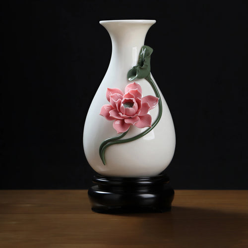 Soft pink lotus relief on a white Dehua pear-shaped porcelain vase