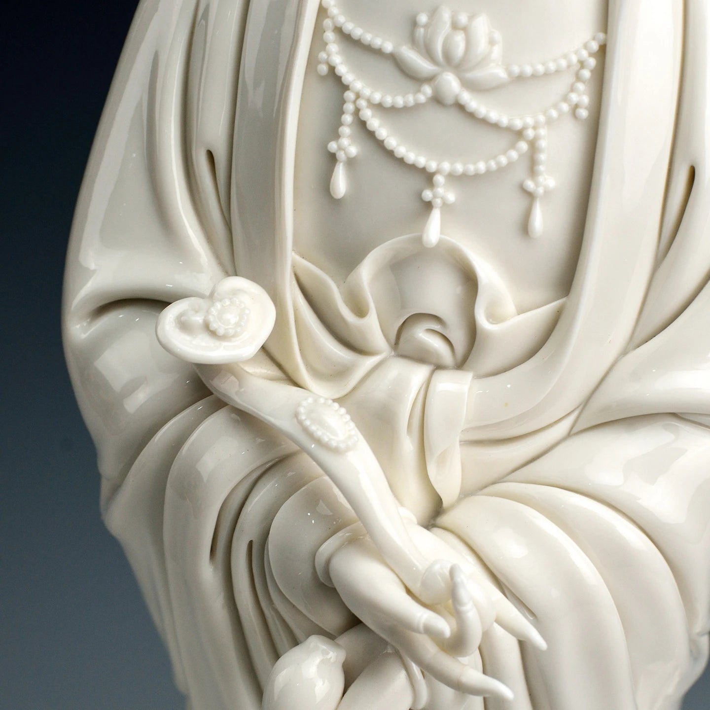Detail of the Guanyin hands holding the traditional ruyi