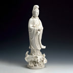 Three-quarter profile showing the tall silhouette of the standing Guanyin