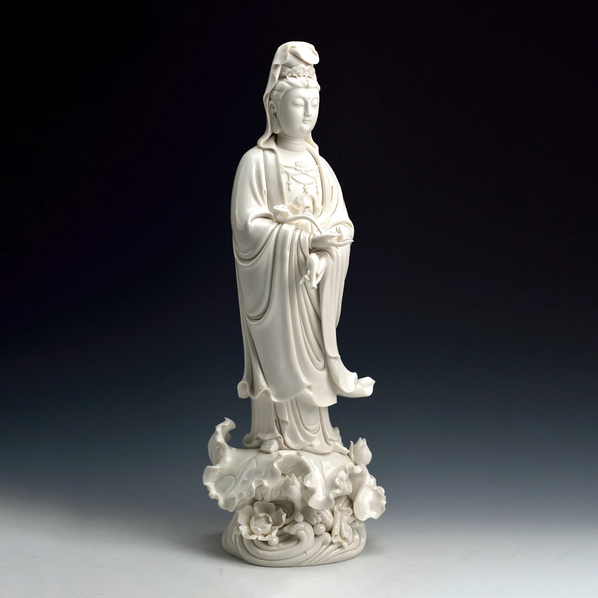 Three-quarter profile showing the tall silhouette of the standing Guanyin