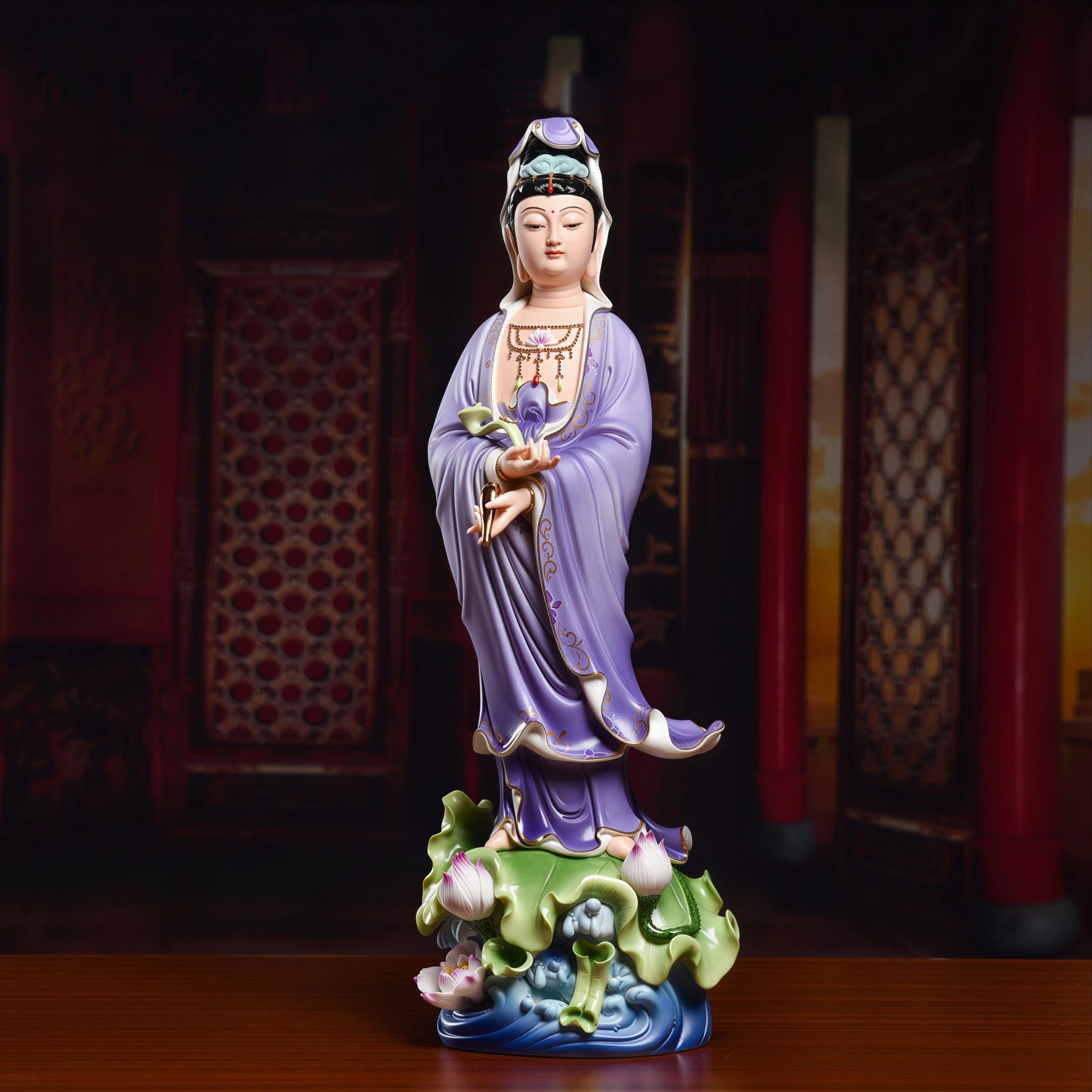 Standing Guanyin holding a ruyi scepter in purple polychrome robes