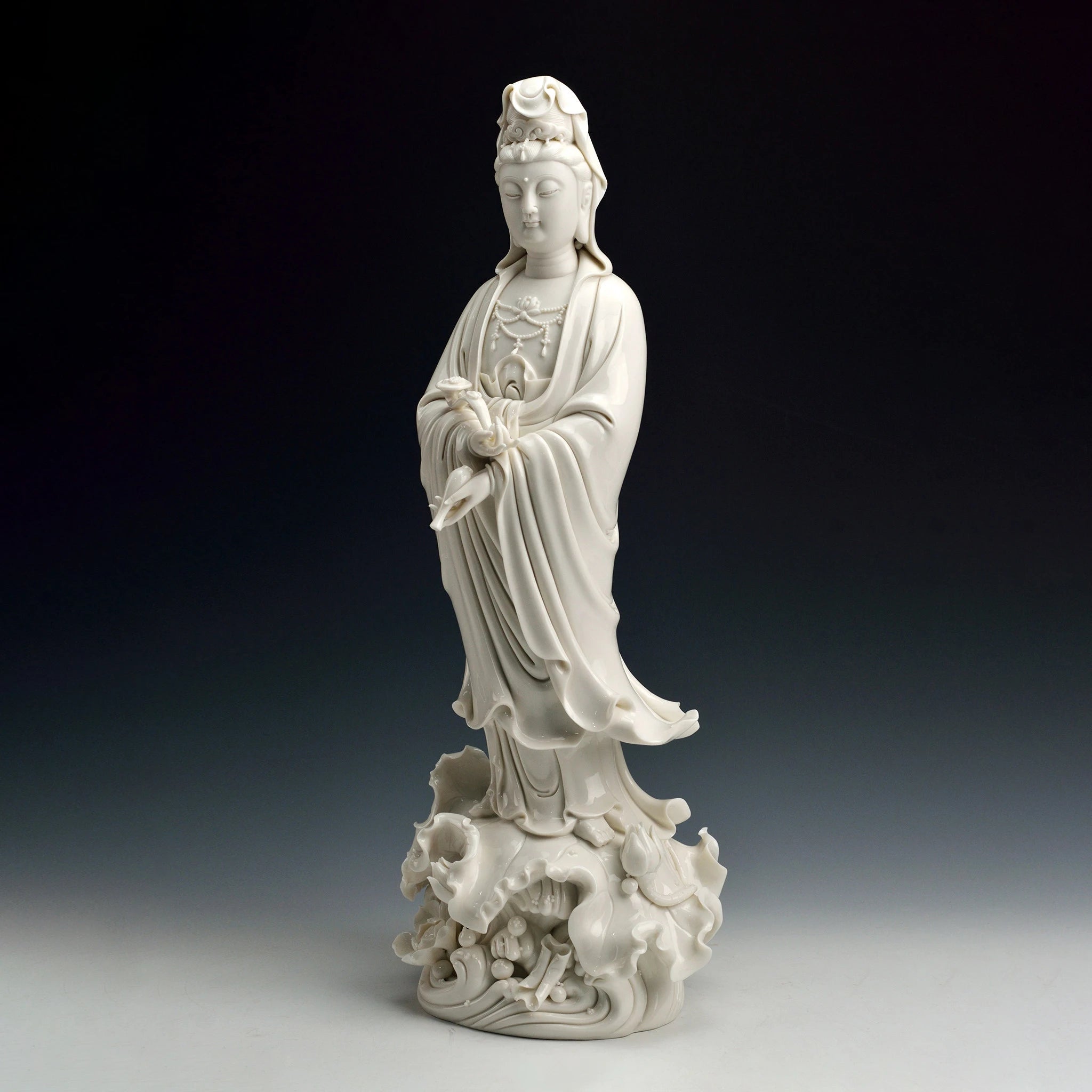 Angled view of the flowing robes and ruyi on the standing Guanyin