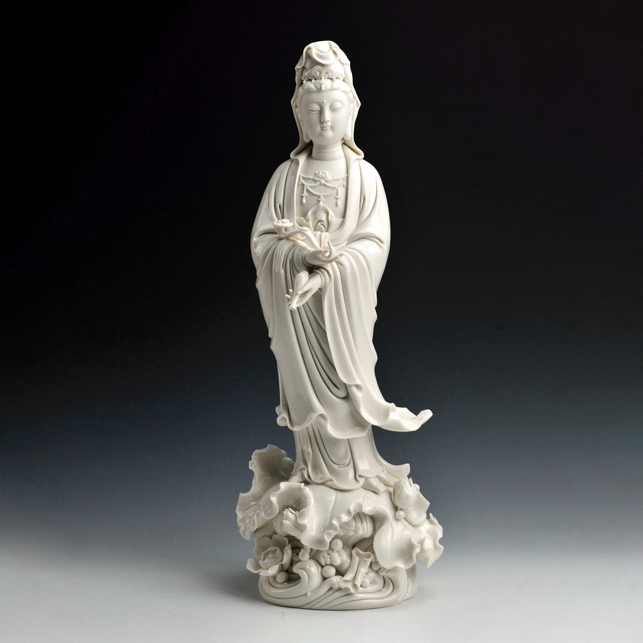 White Dehua porcelain standing Guanyin holding a ruyi scepter
