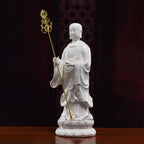 Angled view of the Ksitigarbha sculpture holding the separate gold-toned staff