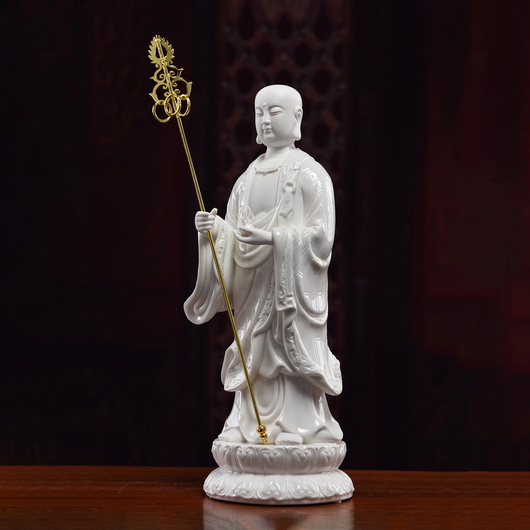 Angled view of the Ksitigarbha sculpture holding the separate gold-toned staff