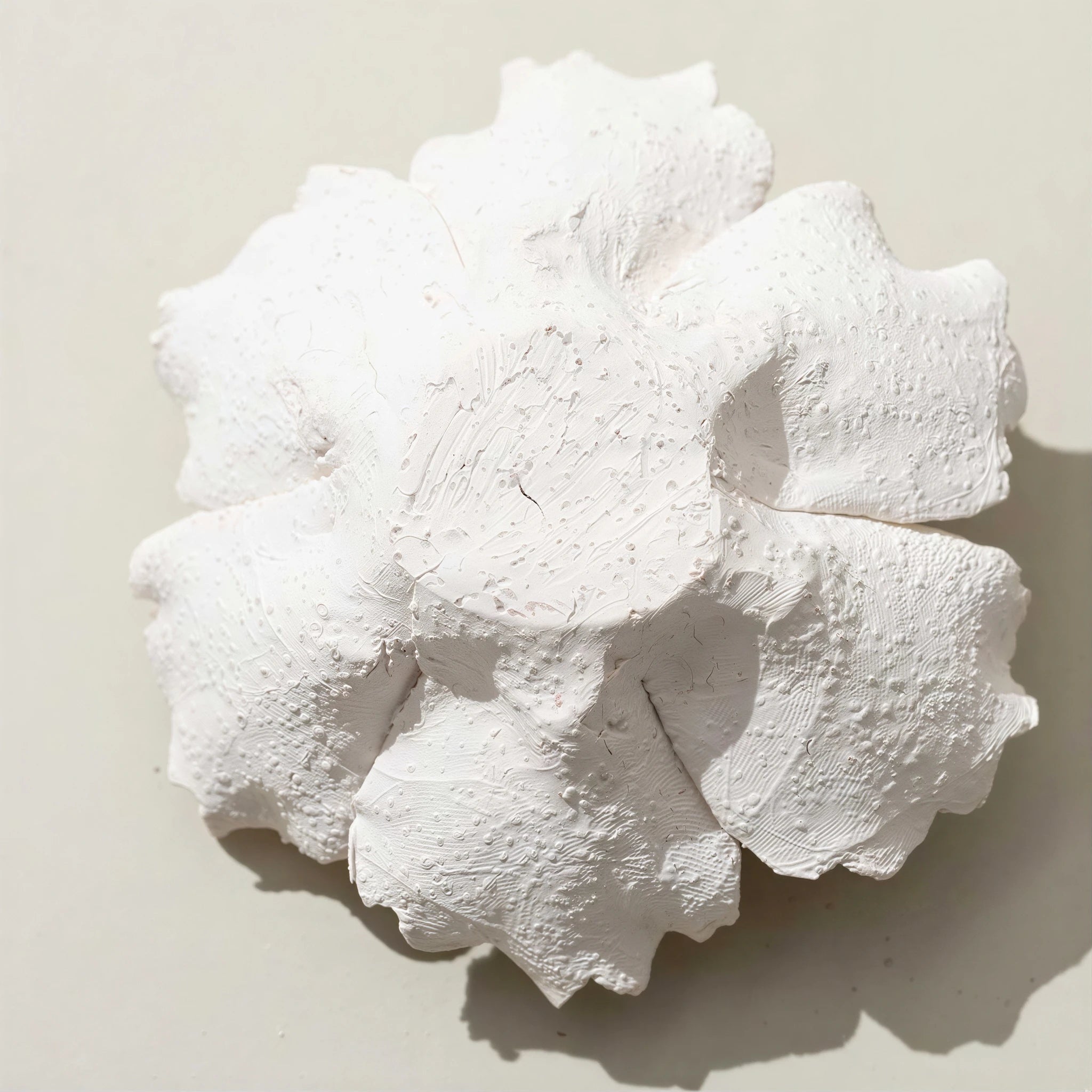 Underside and porous texture of the unglazed ceramic blossom