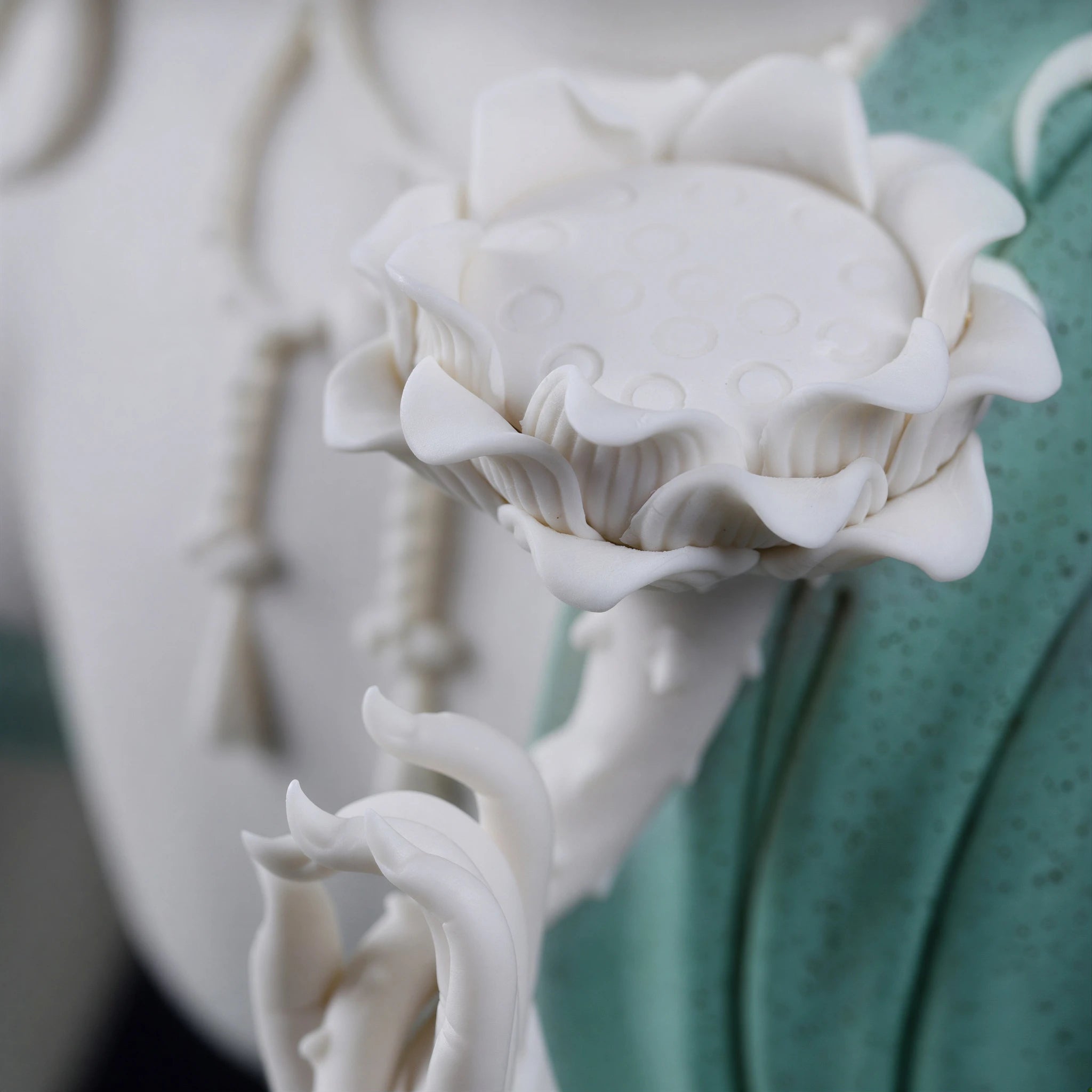 Detail of the porcelain lotus stem held by Water Moon Guanyin