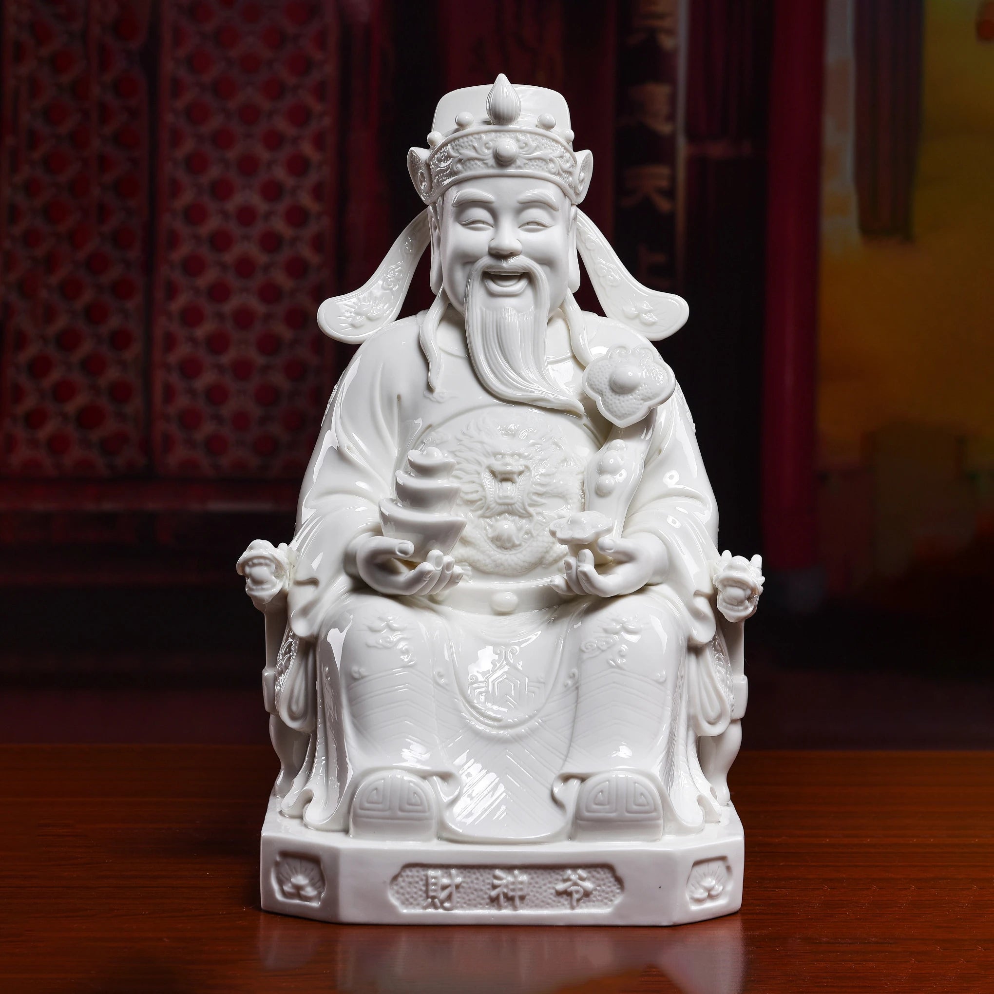 Front view of a white porcelain Wen Caishen with ruyi and ingot