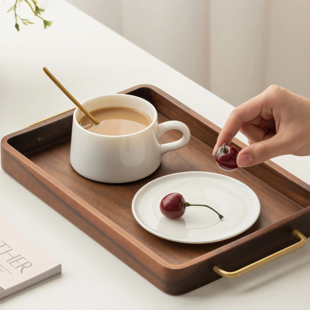 Dehua white porcelain coffee cup on a walnut tray with a separate plate and cherries