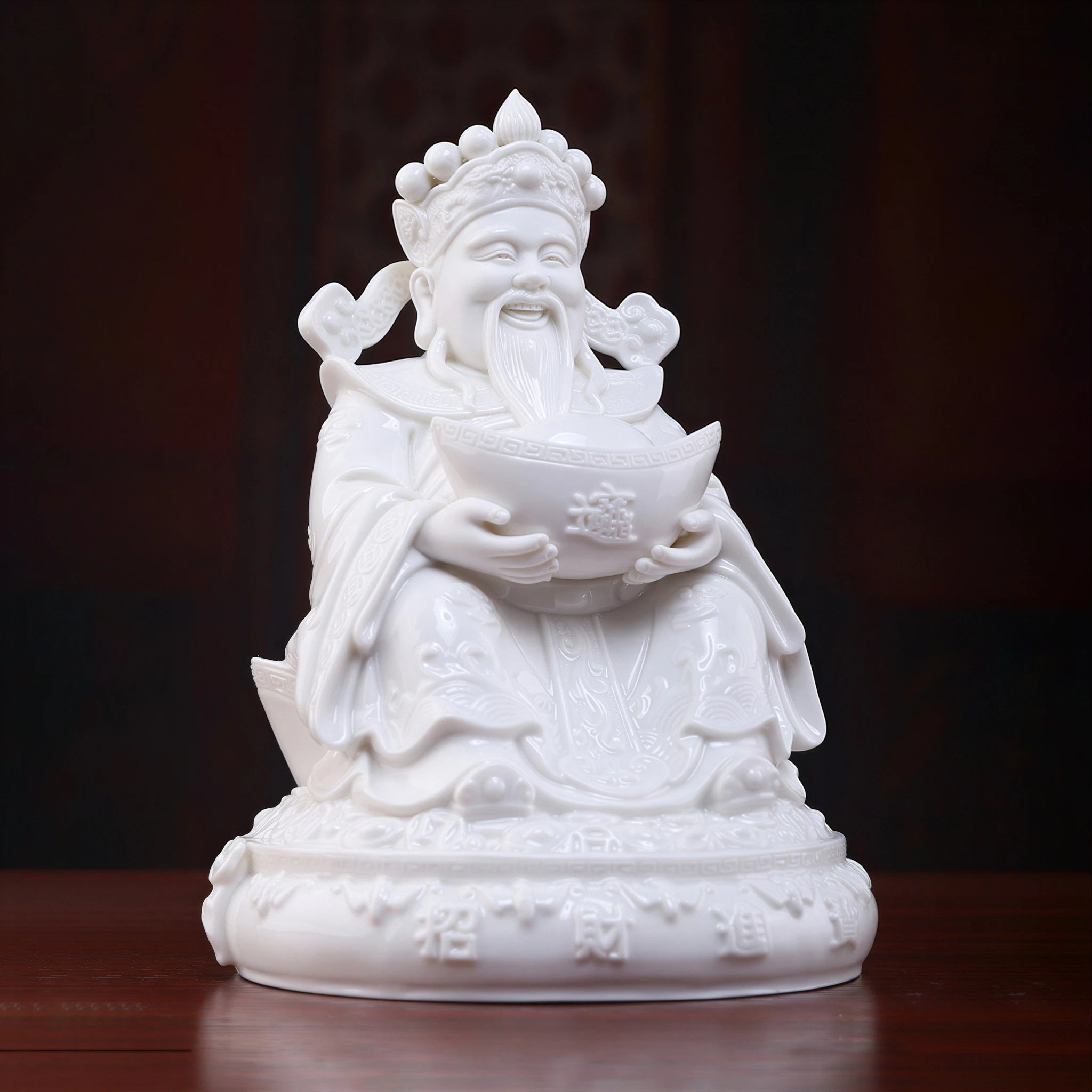 Front view of the white porcelain Fu Bao Caishen seated on a throne