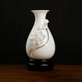 White and gold-toned lotus relief on a Dehua porcelain vase