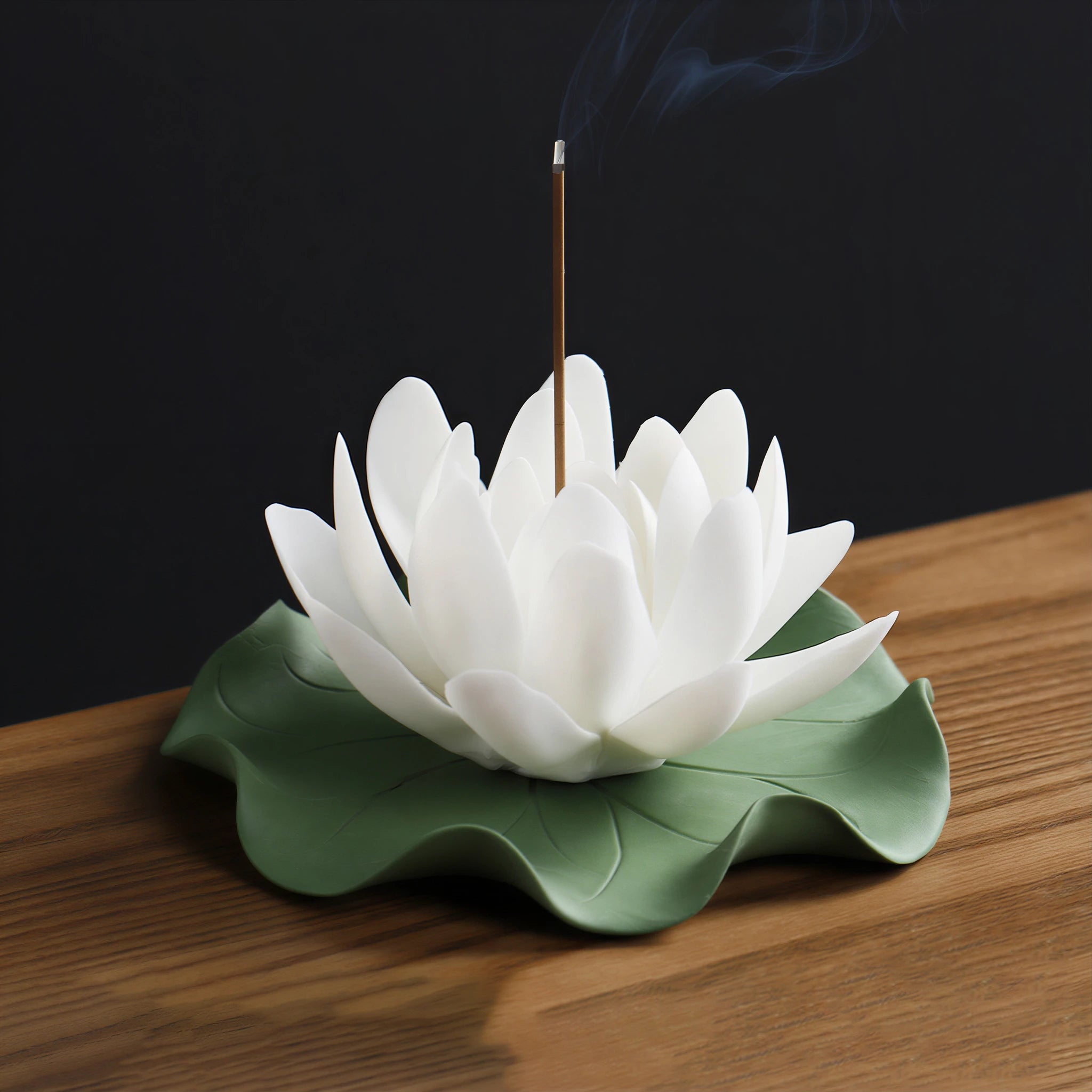 White Dehua porcelain lotus on a green lily pad incense base