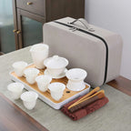 White porcelain gaiwan travel set on a bamboo tray