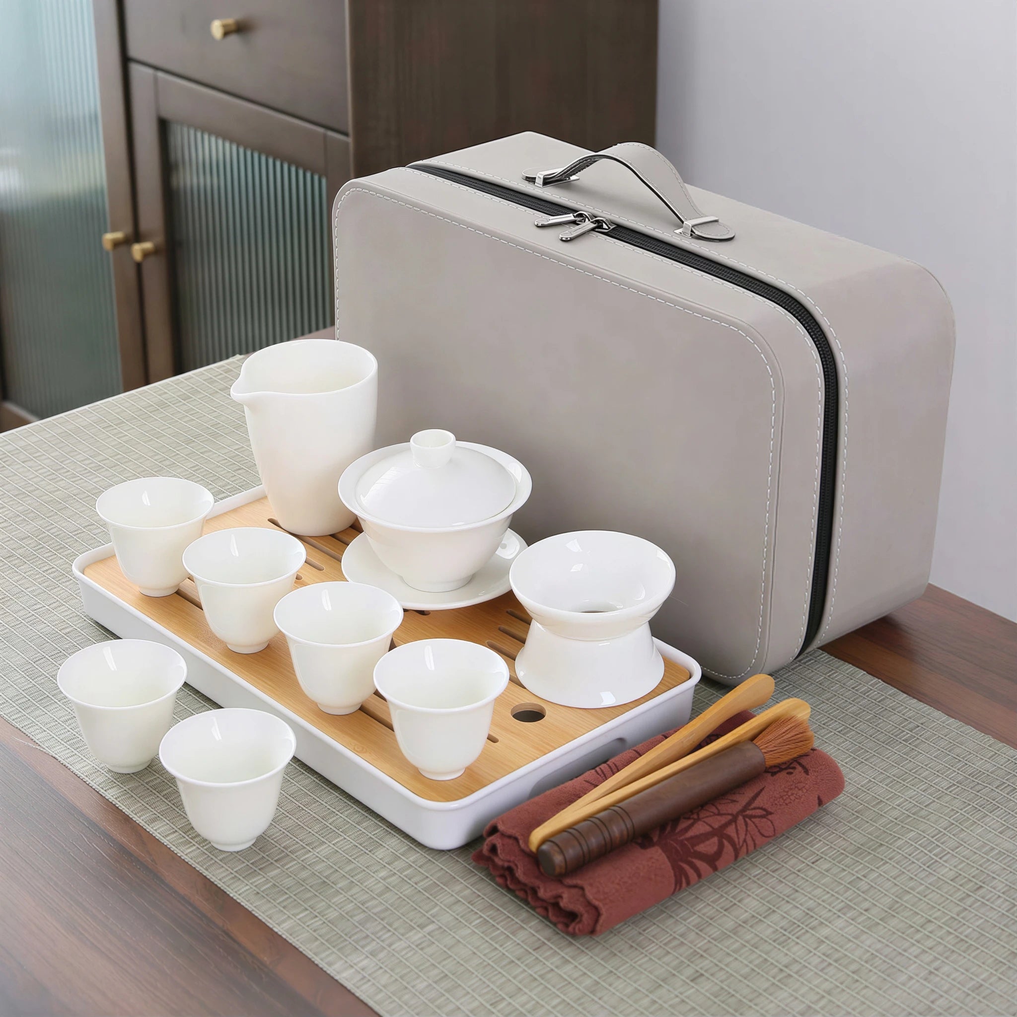 White porcelain gaiwan travel set on a bamboo tray