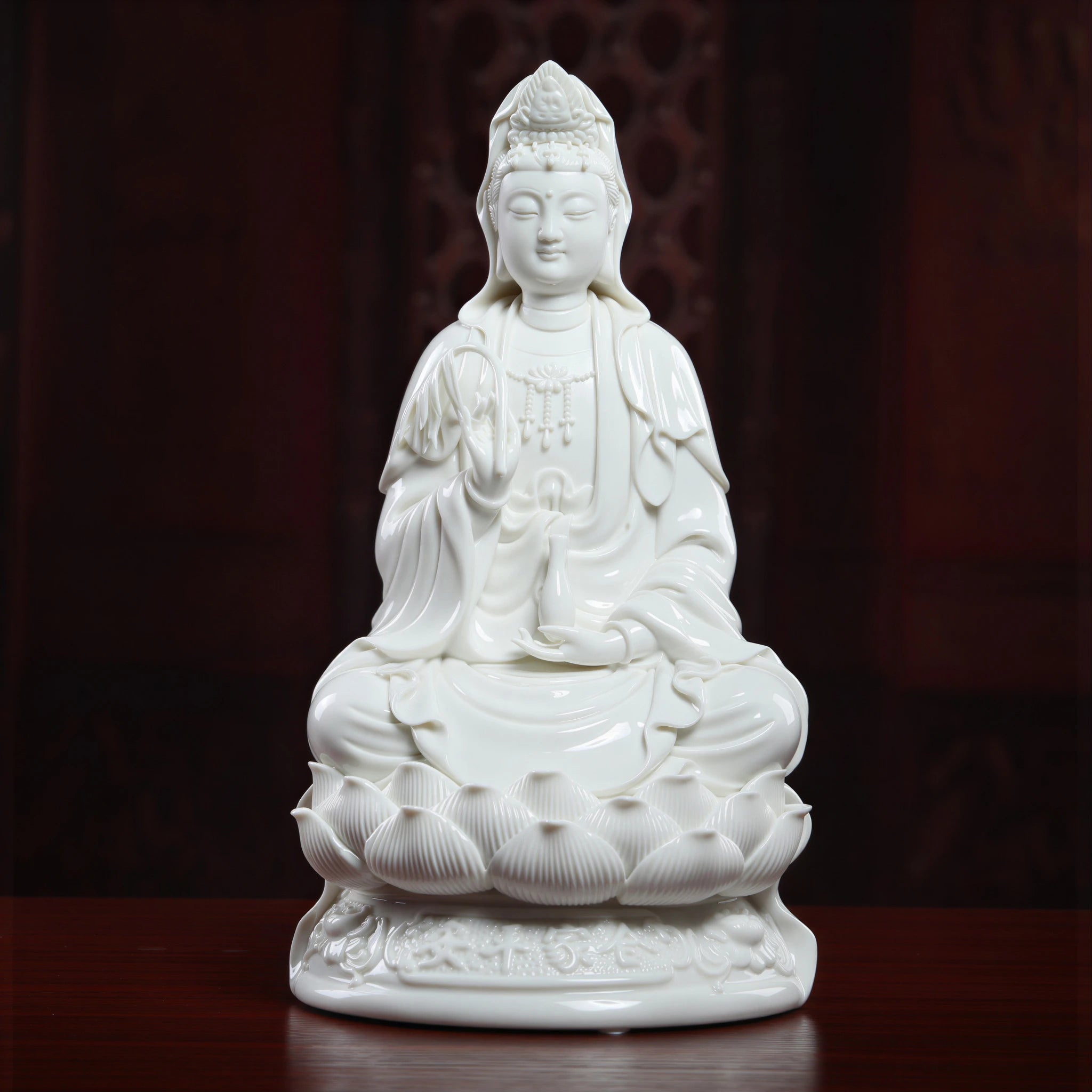 Front view of a white Dehua porcelain Guanyin holding willow and a vase