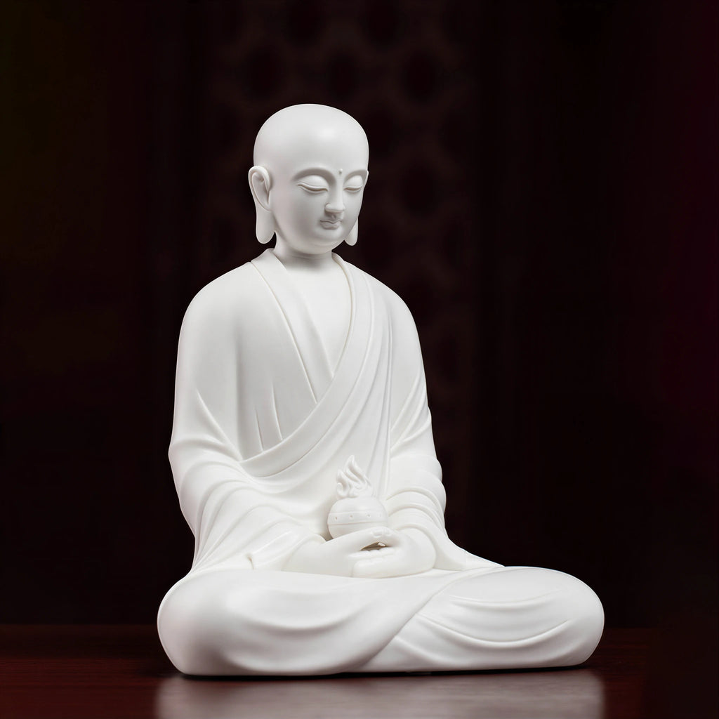 Side view of the white porcelain Ksitigarbha holding a flaming jewel