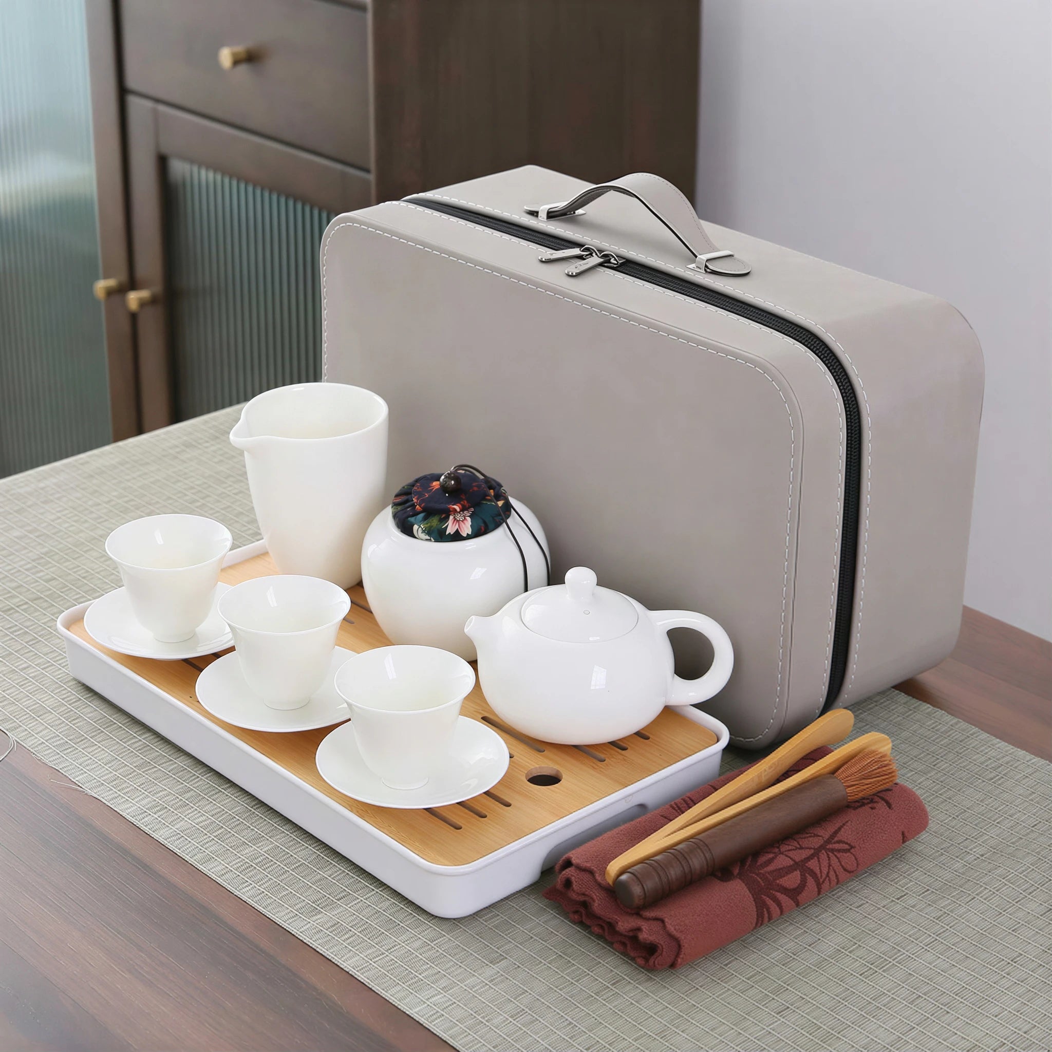 White porcelain Xishi teapot travel set on a bamboo tray