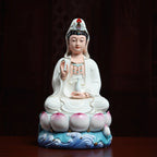 Front view of a white-robed Dehua Guanyin on lotus and waves