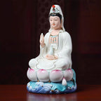 Angled view of the white-robed Guanyin and lotus base
