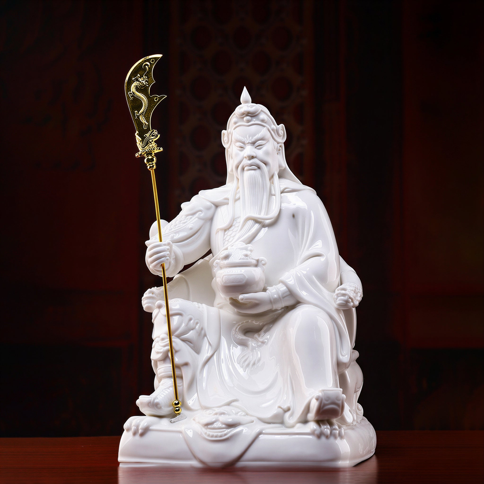 Front view of the seated Guan Gong with gold-colored crescent blade