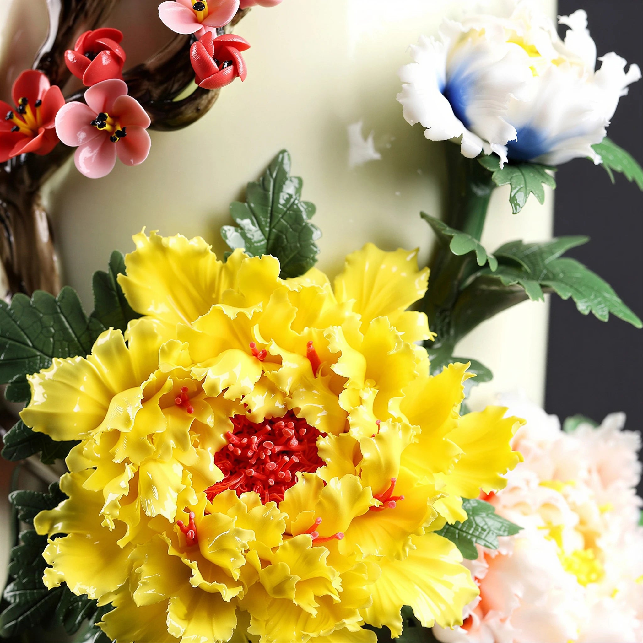 Close view of the yellow peony and layered ceramic petals on the Dehua vase
