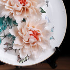 Lower hand-modeled peony detail on the porcelain display plate