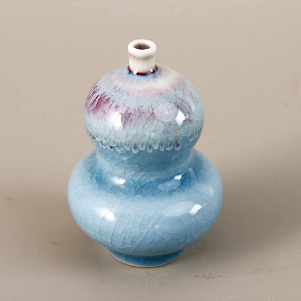 Double-gourd miniature porcelain vase with pale blue reactive glaze and narrow mouth
