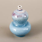 Double-gourd miniature porcelain vase with pale blue reactive glaze and narrow mouth