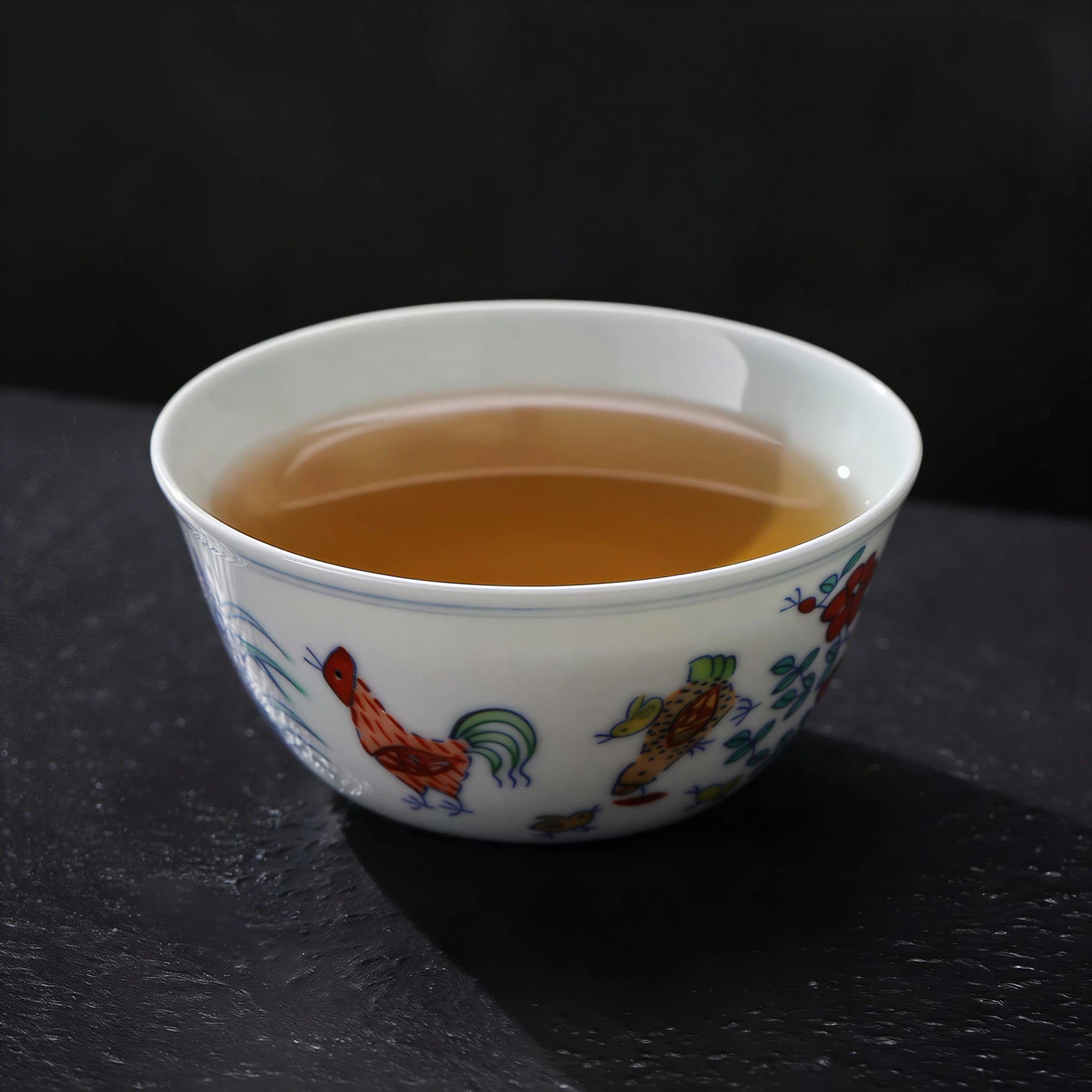 Doucai chicken cup filled with amber-colored tea
