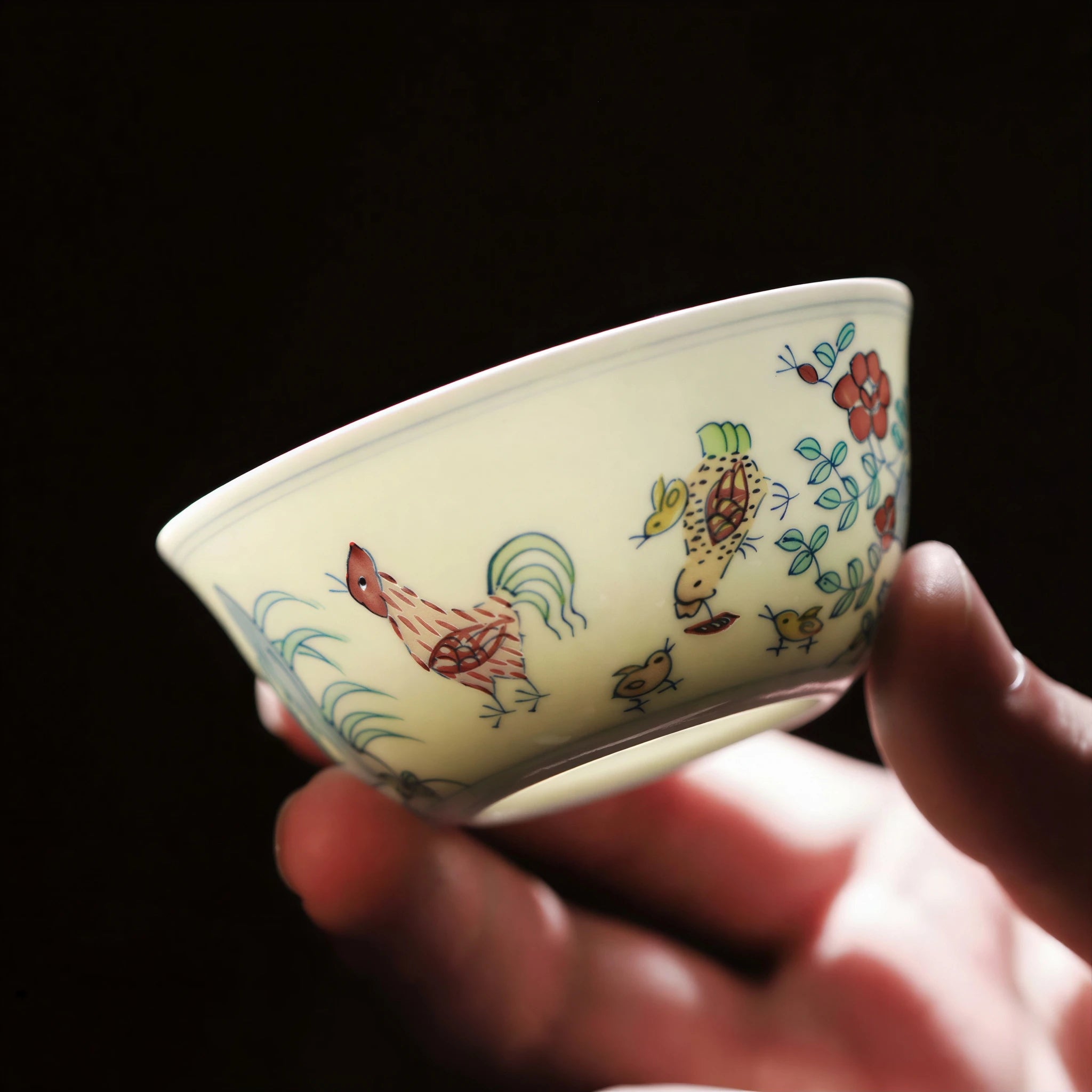 Hand-held Jingdezhen chicken cup showing light through the porcelain body