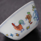Close view of the hand-painted rooster, hen, chicks and colored enamels