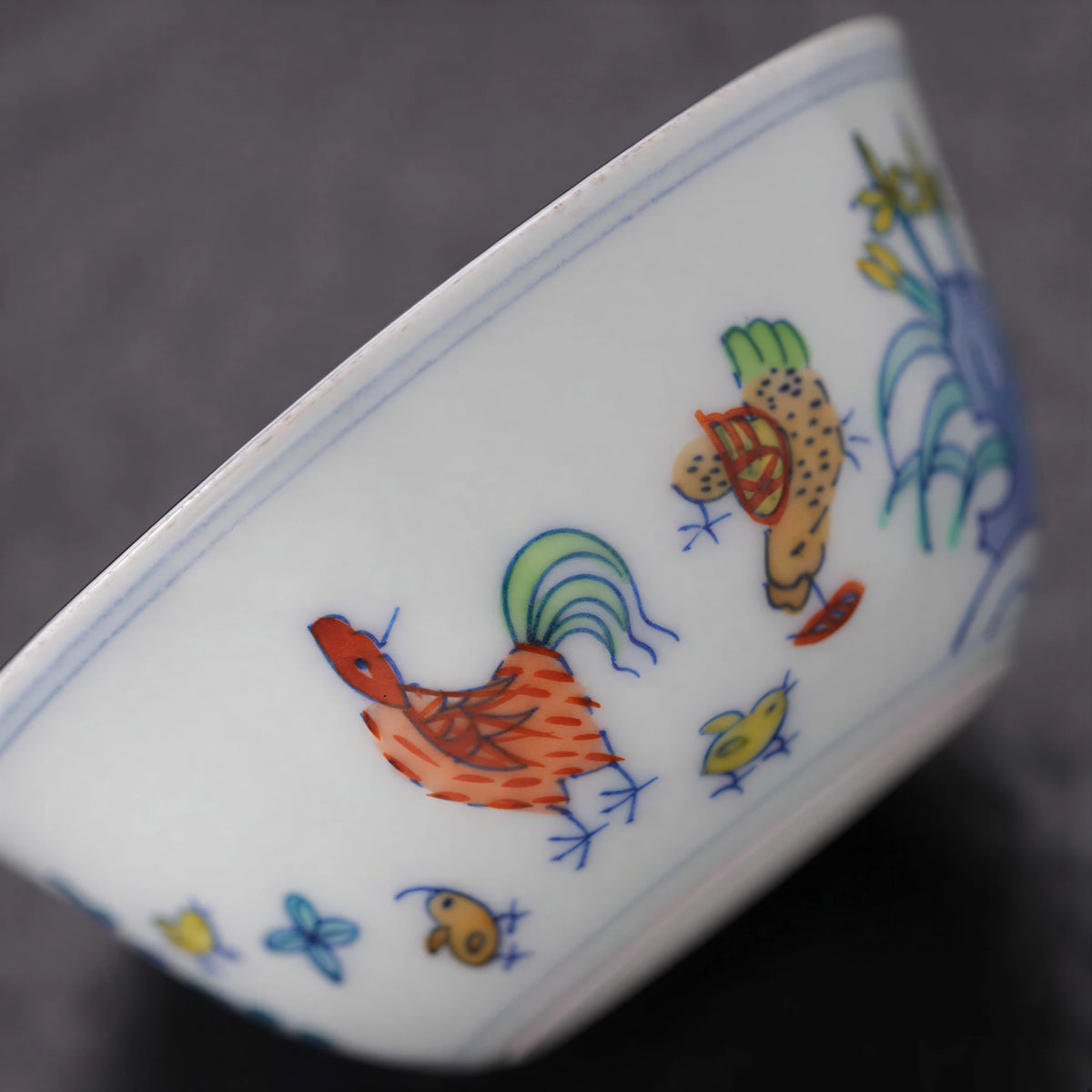 Close view of the hand-painted rooster, hen, chicks and colored enamels