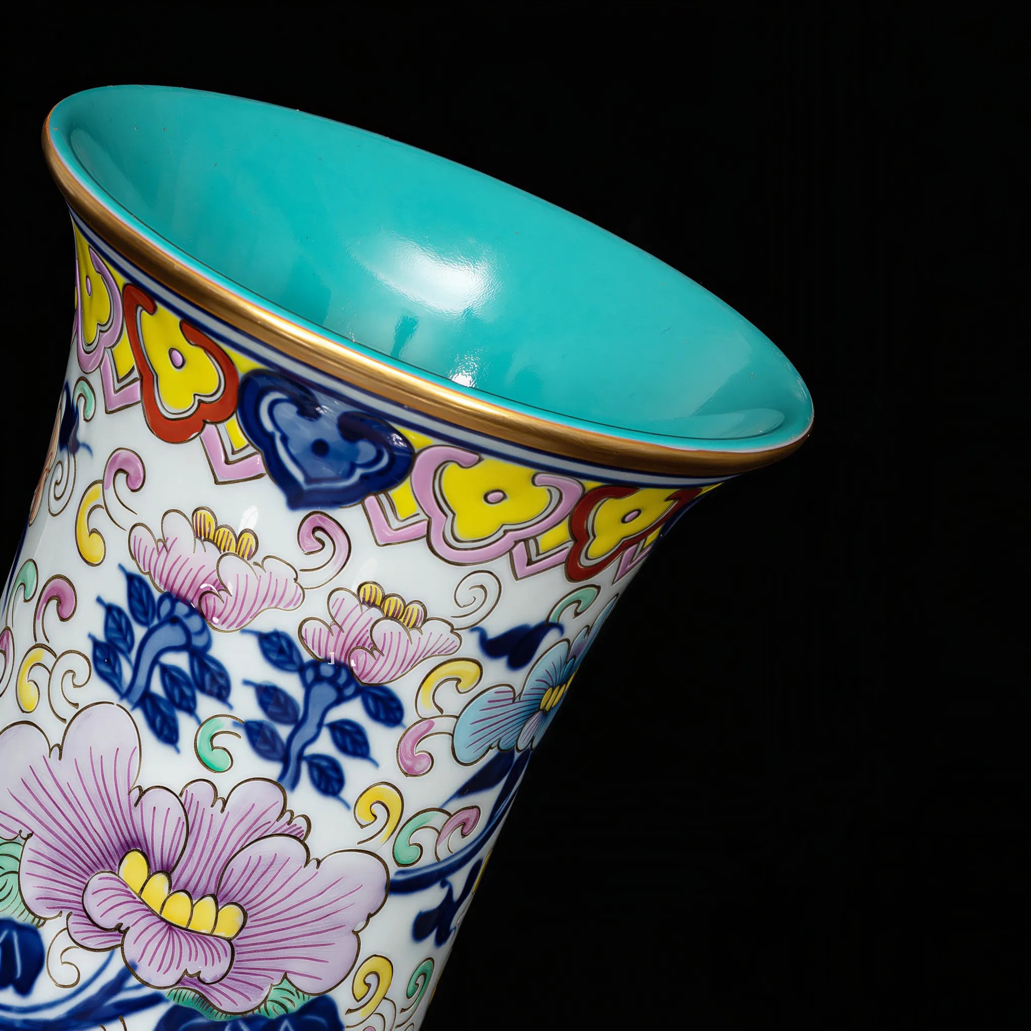Gold-toned rim and neck detail on the doucai vase