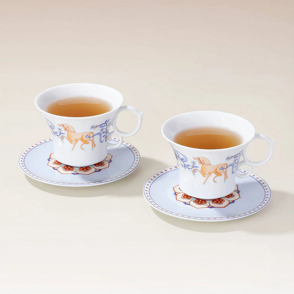 Two Dunhuang-inspired porcelain coffee cups with saucers