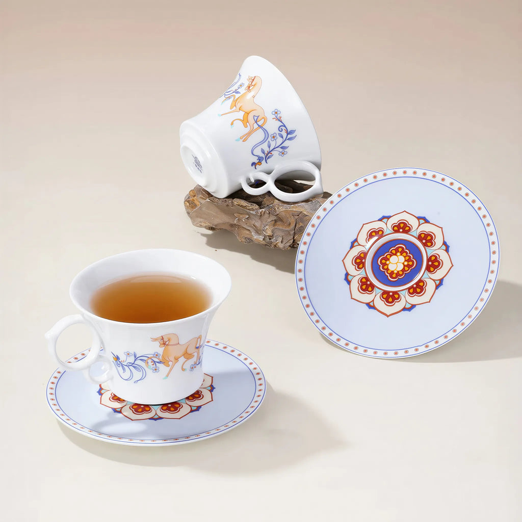 Dunhuang-inspired porcelain coffee cup on a rustic wood table
