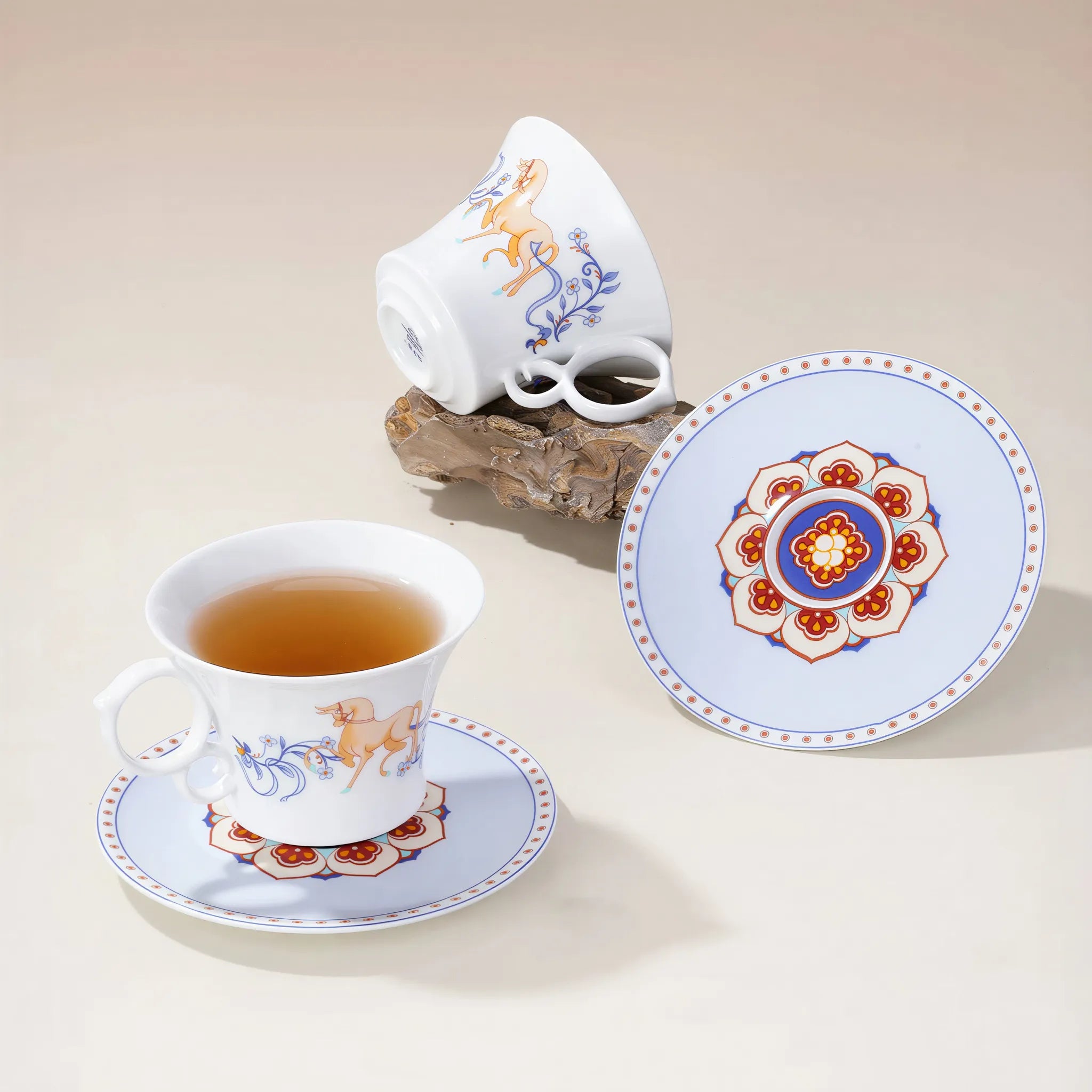 Dunhuang-inspired porcelain coffee cup on a rustic wood table