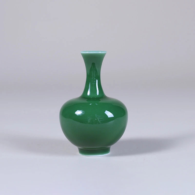 Front view of an emerald-green globular miniature porcelain vase.