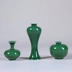 Three emerald-green miniature porcelain vases showing Meiping, squat, and rounded forms.