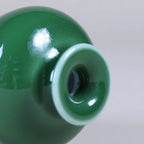 Close view of the narrow mouth opening and glossy emerald-green glaze.